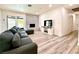 Bright living room with modern flooring, brick fireplace, sliding glass doors and a comfortable, neutral color palette at 4881 E Imperial Ave, Las Vegas, NV 89104