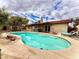 Inviting backyard pool and patio area featuring chaise lounges, patio furniture, a fire pit, and a covered patio at 4881 E Imperial Ave, Las Vegas, NV 89104