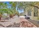 Relaxing backyard featuring a patio seating area and lush tropical landscaping at 5068 Rivedro St, Las Vegas, NV 89135
