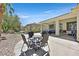 Spacious backyard with covered patio, seating area, lush landscaping, and serene pond at 5068 Rivedro St, Las Vegas, NV 89135