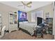 Cozy bedroom featuring a fan, a large window, and unique décor at 5068 Rivedro St, Las Vegas, NV 89135