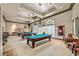 Billiards room featuring multiple tables, stylish lighting, and ample seating areas at 5068 Rivedro St, Las Vegas, NV 89135