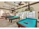 Billiards room featuring multiple tables, stylish lighting, and ample seating areas at 5068 Rivedro St, Las Vegas, NV 89135
