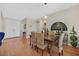Elegant dining room with hardwood floors, a wooden table with seating for six, and stylish decor at 5068 Rivedro St, Las Vegas, NV 89135