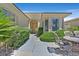 Well-maintained home exterior featuring manicured landscaping, an arched entryway, and a cozy patio set at 5068 Rivedro St, Las Vegas, NV 89135