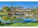 Beautiful community clubhouse with lush landscaping and a tranquil pond with a waterfall at 5068 Rivedro St, Las Vegas, NV 89135