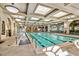 Bright indoor pool features skylights, murals, and numerous lounge chairs at 5068 Rivedro St, Las Vegas, NV 89135