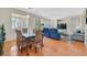 Hardwood dining area flows into the living room featuring comfortable seating and lots of natural light at 5068 Rivedro St, Las Vegas, NV 89135
