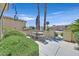 Relaxing outdoor patio area with wrought iron table and chairs surrounded by lush greenery at 5068 Rivedro St, Las Vegas, NV 89135
