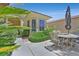 Inviting outdoor patio with decorative table and chairs, perfect for relaxing or entertaining guests at 5068 Rivedro St, Las Vegas, NV 89135