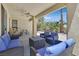 Covered patio featuring comfortable outdoor seating, a ceiling fan, and serene backyard views at 5068 Rivedro St, Las Vegas, NV 89135
