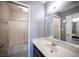 Bathroom featuring a large mirror, a white vanity and a shower-tub combination at 5241 Janfred Ct # 18, Las Vegas, NV 89103