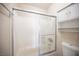 Bright bathroom with a shower-tub, glass door and white storage cabinet at 5241 Janfred Ct # 18, Las Vegas, NV 89103