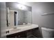 Bathroom features a long vanity, large mirror, modern toilet, and a neutral color scheme at 5241 Janfred Ct # 18, Las Vegas, NV 89103