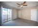 Carpeted bedroom featuring a ceiling fan and large window with curtains at 5241 Janfred Ct # 18, Las Vegas, NV 89103