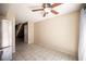 Open dining room with modern tile flooring, ceiling fan, and stainless steel refrigerator at 5241 Janfred Ct # 18, Las Vegas, NV 89103