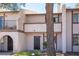Exterior view of a two-story townhome featuring a quaint facade and inviting entryway at 5241 Janfred Ct # 18, Las Vegas, NV 89103