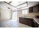 Kitchen and dining area featuring matching stainless steel appliances and brown cabinetry at 5241 Janfred Ct # 18, Las Vegas, NV 89103