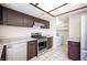 The kitchen is equipped with stainless steel appliances, dark cabinets, and access to the laundry room at 5241 Janfred Ct # 18, Las Vegas, NV 89103