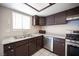 Traditional kitchen features stainless steel appliances, white countertops, and dark brown cabinetry at 5241 Janfred Ct # 18, Las Vegas, NV 89103