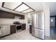 Updated kitchen featuring stainless steel appliances and stylish brown cabinetry at 5241 Janfred Ct # 18, Las Vegas, NV 89103