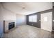 Bright living room with tile floor, fireplace, and plenty of natural light from the large window at 5241 Janfred Ct # 18, Las Vegas, NV 89103