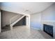 Spacious living room featuring tile flooring, a cozy fireplace, and a staircase at 5241 Janfred Ct # 18, Las Vegas, NV 89103