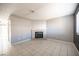 Neutral living room featuring a brick fireplace, tile flooring, and ample natural light at 5241 Janfred Ct # 18, Las Vegas, NV 89103