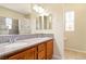 Bathroom with dual sinks, granite countertop, and decorative tile shower with windows at 5380 Flowing Spring St, Las Vegas, NV 89122