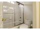 Bathroom featuring a shower-tub combo with glass doors, and a standard toilet at 5380 Flowing Spring St, Las Vegas, NV 89122