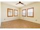 Bright bedroom featuring tile floors and large shuttered windows that fill the room with natural light at 5380 Flowing Spring St, Las Vegas, NV 89122