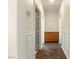 Well-lit hallway with wood cabinet and paneled walls, leading to various rooms at 5380 Flowing Spring St, Las Vegas, NV 89122