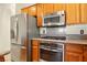 Modern kitchen with stainless steel appliances, light wood cabinets, and granite countertops at 5380 Flowing Spring St, Las Vegas, NV 89122