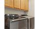 Modern laundry room featuring newer model washer and dryer, and wooden cabinets at 5380 Flowing Spring St, Las Vegas, NV 89122