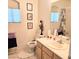 Bright bathroom with a peach sink, toilet, framed art, and bathtub with floral curtain at 5415 W Harmon Ave # 2094, Las Vegas, NV 89103