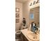 Well-lit bathroom with single sink vanity and framed mirrors at 5415 W Harmon Ave # 2094, Las Vegas, NV 89103