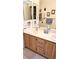 Bathroom featuring dual sink vanity with lots of framed art hanging above at 5415 W Harmon Ave # 2094, Las Vegas, NV 89103