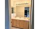 Bathroom featuring a double sink vanity with ample storage, and large mirror, creating a functional space at 5415 W Harmon Ave # 2094, Las Vegas, NV 89103