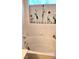 Clean white tiled bathtub with tulips displayed on the ledge above at 5415 W Harmon Ave # 2094, Las Vegas, NV 89103