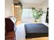 Bedroom featuring a full bed and a striking headboard, complemented by a decorative plant, and wooden furniture at 5415 W Harmon Ave # 2094, Las Vegas, NV 89103