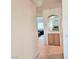 Hallway view with an archway to a kitchen area and a bedroom in the distance at 5415 W Harmon Ave # 2094, Las Vegas, NV 89103