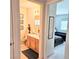 Hallway view of a bathroom with framed art and a bedroom with twin beds at 5415 W Harmon Ave # 2094, Las Vegas, NV 89103