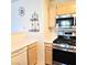Efficient kitchen equipped with stainless steel appliances, light wood cabinets, and ample counter space at 5415 W Harmon Ave # 2094, Las Vegas, NV 89103