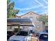 Assigned covered parking space with unit number, surrounded by mature trees and parked cars on a sunny day at 5415 W Harmon Ave # 2094, Las Vegas, NV 89103