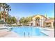 Inviting community pool surrounded by lush greenery and comfortable lounge area at 5415 W Harmon Ave # 2094, Las Vegas, NV 89103