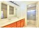 Bright bathroom features a double sink vanity and a shower over tub with sliding glass doors at 5536 Cleary Ct, Las Vegas, NV 89108