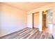 Freshly painted bedroom with wood-look flooring features a closet with sliding doors at 5536 Cleary Ct, Las Vegas, NV 89108
