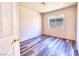 Clean bedroom with wood-look flooring is bright with a single window and freshly painted walls at 5536 Cleary Ct, Las Vegas, NV 89108