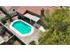 Aerial view of a backyard featuring a sparkling pool, patio, and landscaping at 608 Blooming View Ave, North Las Vegas, NV 89032