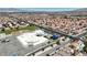 High angle aerial shot showing a school amid a neighborhood with red tile roofed homes, offering a sense of community at 608 Blooming View Ave, North Las Vegas, NV 89032